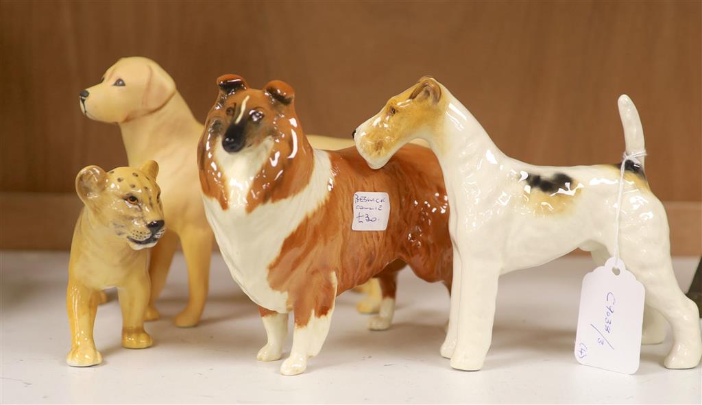 Three Beswick dogs and a similar lion cub